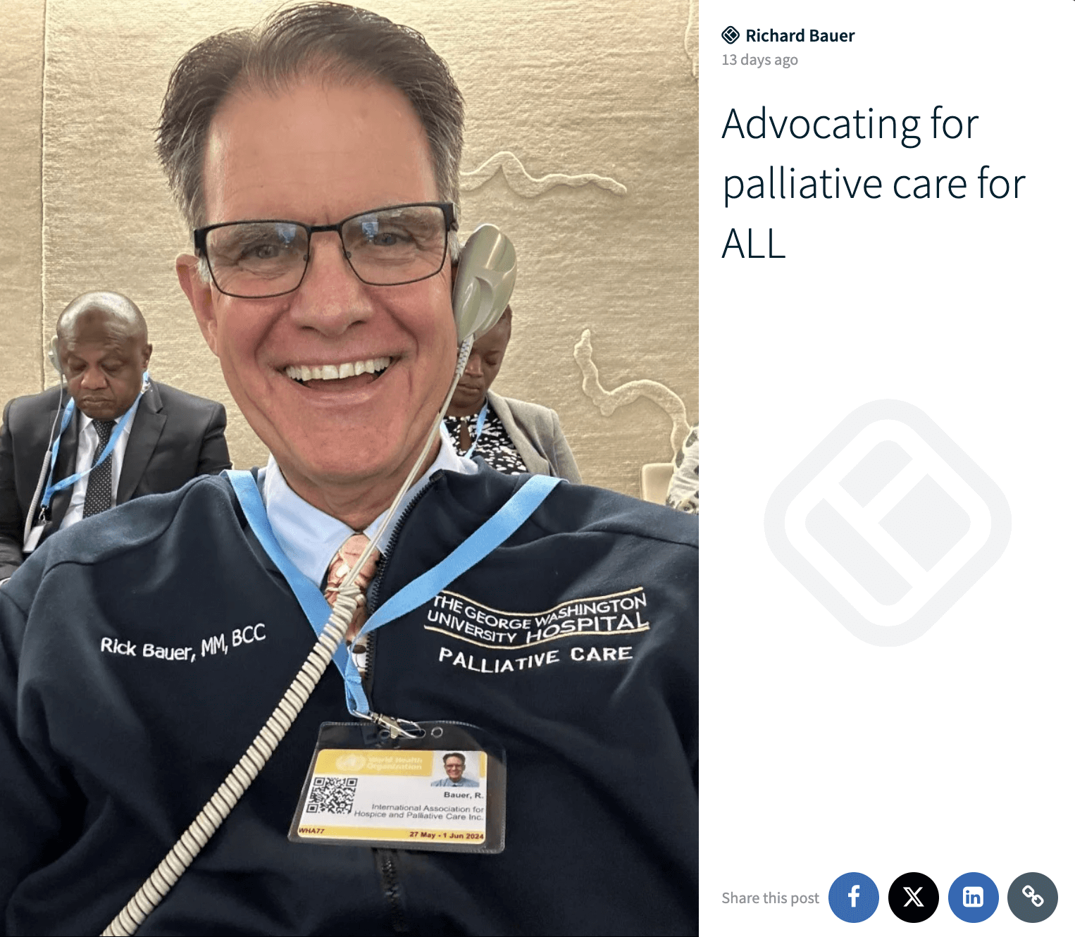 A man, identified as Rick Bauer, smiles for a selfie, wearing a badge and a jacket from The George Washington University Hospital's Palliative Care department, advocating for palliative care for all, with other attendees visible in the background.