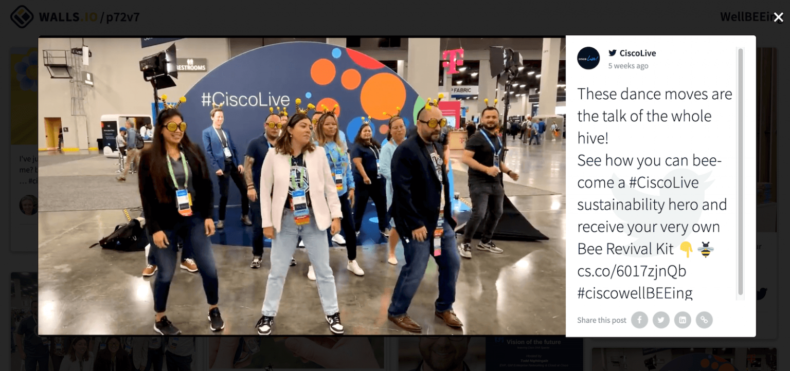 Participants dancing in a group at a Cisco Live event, with a tweet displayed alongside promoting the activity and using branded hashtags.